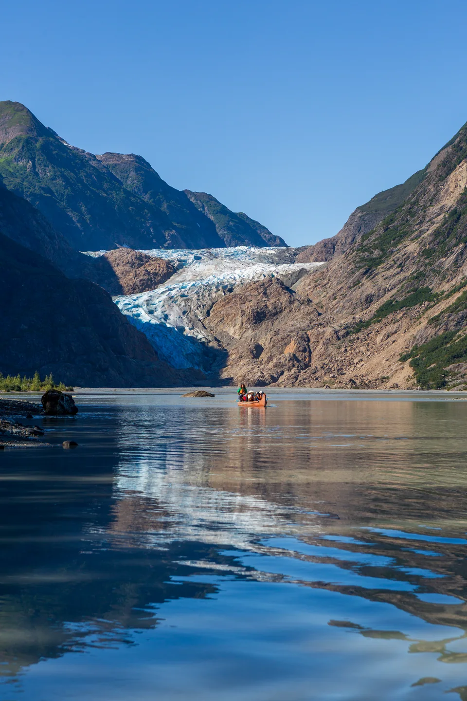 Guests canoe beneath Davidson Glacier in Alaska